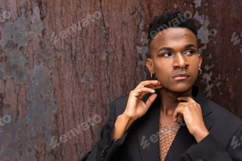 Preview: A black ethnic man in a fashion pose on a brown metallic background