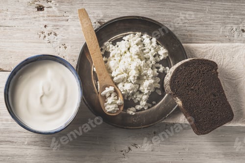 Preview: Fresh cottage cheese on the metal plate with bread on the white wooden table top view