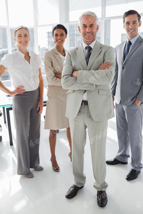Preview: Cheerful Businessman Standing In Front Of Colleagues In The Meeting Room