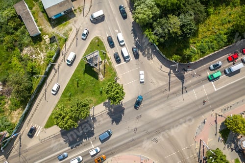 Preview: Top down aerial view of busy street intersection with moving cars traffic.