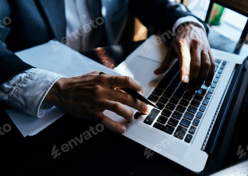 Preview: business man in suit in front of laptop with book work communication technology
