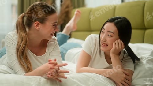 Preview: Two happy multiracial multiethnic women friends female diversity girls Caucasian woman talking with