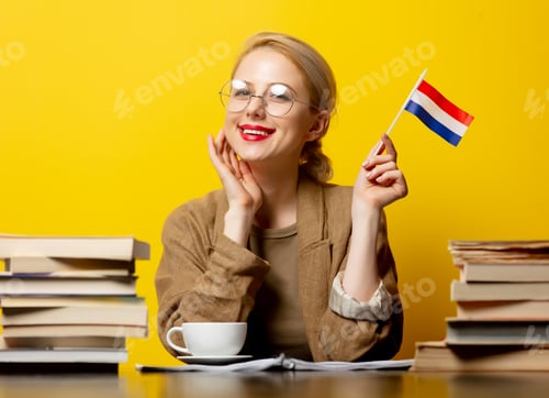 Preview: Style blonde womansitting at table with books and flag of Netherlands on yellow background