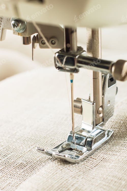 Preview: Close-up of modern sewing machine presser foot and needle sewing item of clothes.