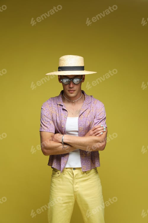 Preview: Fashionable portrait of handsome man in stylish outfit on color background