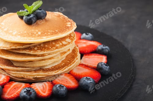 Preview: Delicious pancakes close up, with fresh blueberries on rusty background. Top view