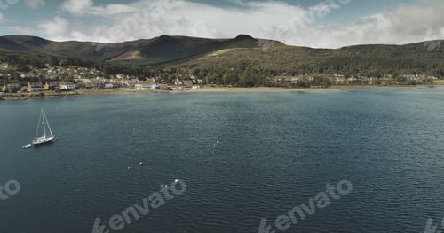 Preview: Atlantic ocean gulf, sailboats aerial zooming shot in Brodick Bay. Scottish landscape of port town