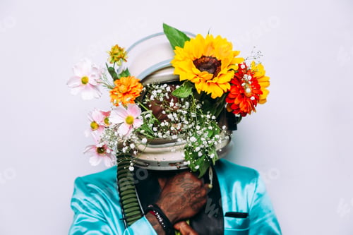 Preview: fine art concept with man wearing a space helmet and flowers composition