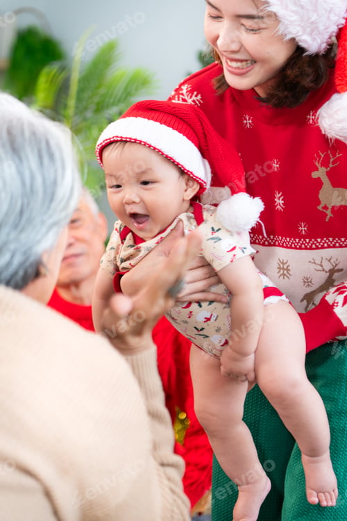 Preview: Little child with a joyful moment for a large family celebrating together at home