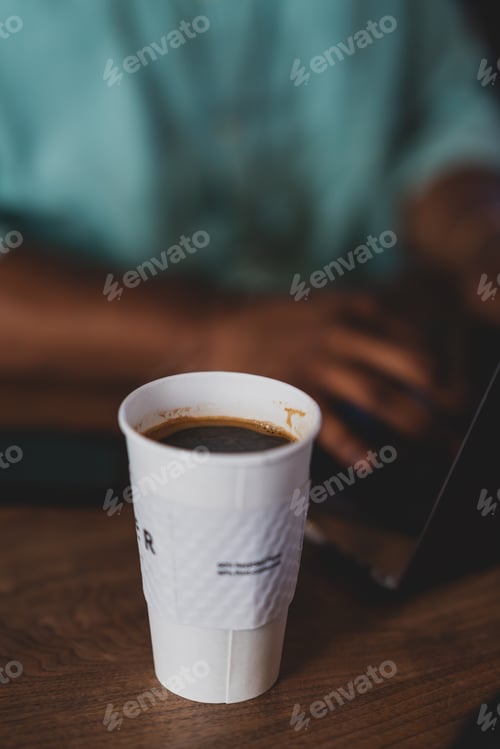 Preview: Coffee with man working on laptop