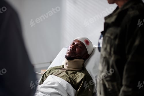 Preview: Wounded soldier lying on bed in hospital