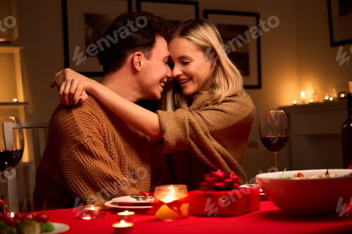 Preview: Happy affectionate couple hugging celebrating Valentines day dining together.