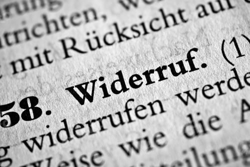 Preview: Closeup of the german word Widerruf written in bold font surrounded by blurred words