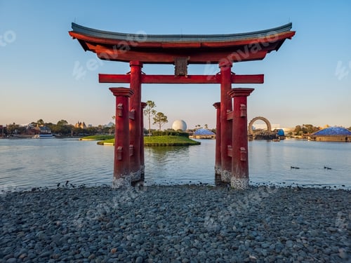 Preview: a red tori tori gate in front of a lake and the city skyline
