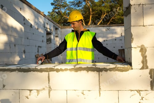Preview: Construction worker at construction site measures the length of the window opening and the wall