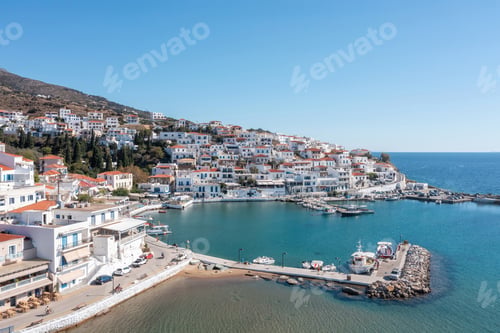 Preview: Andros island, Batsi village Cyclades destination Greece. Aerial drone view of port, boat, sea, sky.
