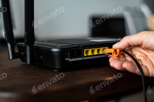 Preview: Man plugging in an ethernet cable to a wireless router