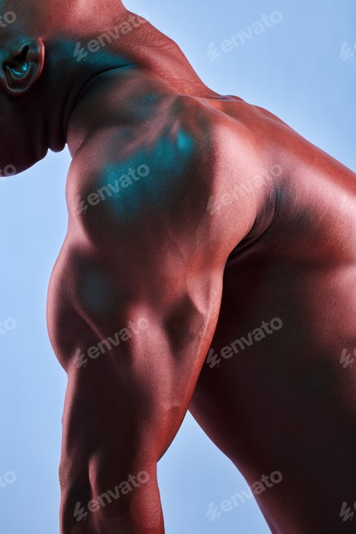 Preview: Put in the work and lift heavy. Shot of a muscular man posing against a studio background.