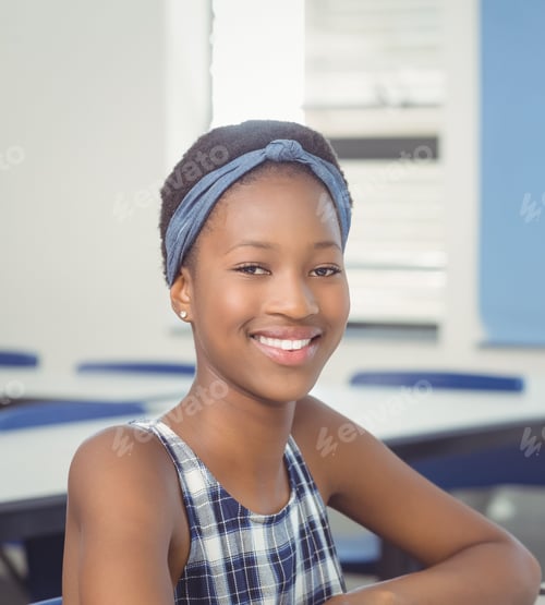 Preview: African American girl sitting at desk at school wearing plaid top and headband with window blinds