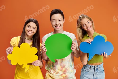 Preview: cheerful adolescent interracial boy and girls holding thought and speech bubbles, friendship day