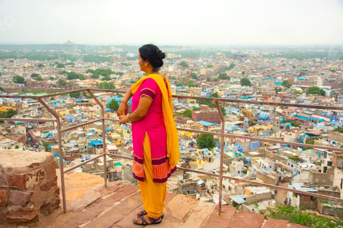 Preview: Portrait of Indian woman against view of Jodhpur the blue city in Rajasthan India