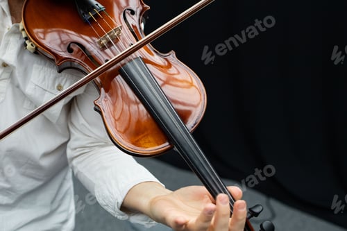 Preview: Close-up shot of a person playing on a violin