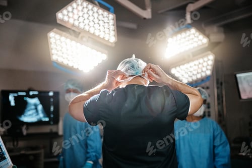 Preview: Medical, clothes and doctor in operating room for surgery, safety and protection in theatre. Health