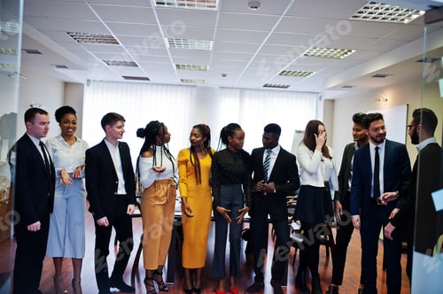 Preview: Multiracial young creative people in modern office
