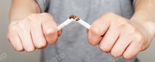 Preview: young woman holding a broken cigarette in her hands close. banner