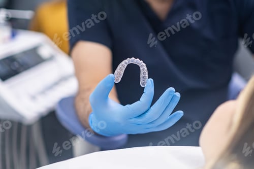 Preview: Professional orthodontist showing innovative aligners to camera designed for bite correction