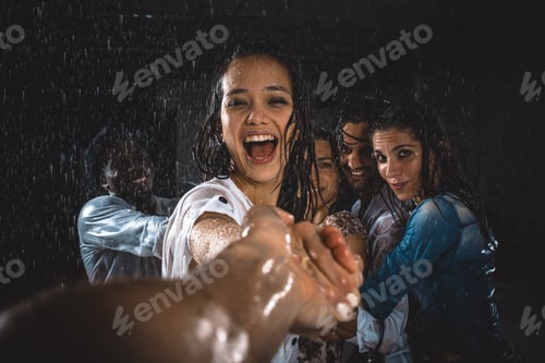Preview: Group of friends dancing in the rain