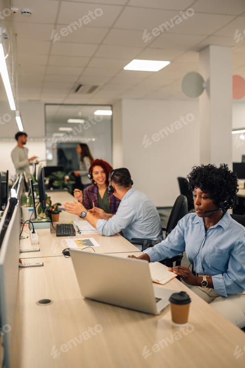 Preview: A customer support agents sitting at call center and talking to clients.