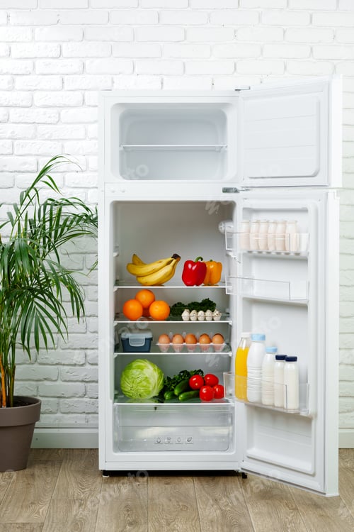 Preview: White Refrigerator Open With Fresh Produce and Dairy