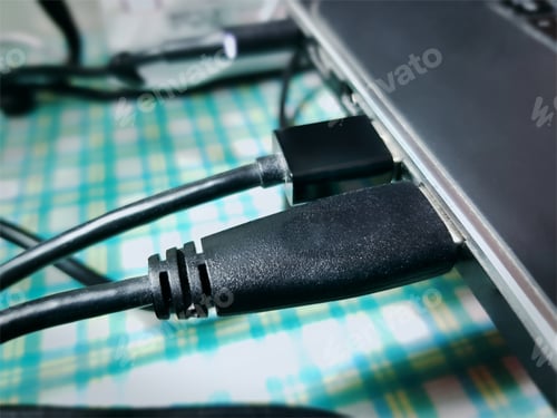 Preview: Close-up Black USB Cable Connected to a Laptop