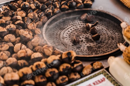 Preview: Roasted chestnuts on pan, delicious street snack at local market