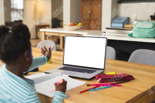 Preview: African american girl sitting at table using laptop with copy space for online lesson