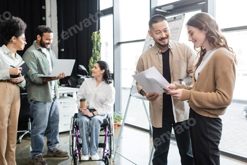 Preview: diversity and inclusion, happy asian man communicating with woman near disabled female coworker
