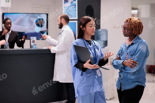 Preview: Asian nurse showing healthcare diagnosis to patient