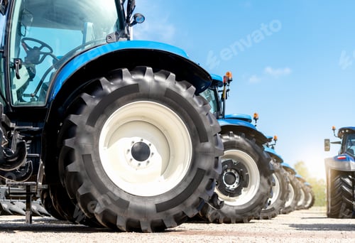 Preview: Agricultural equipment dealership background. Row of farm tractors low view
