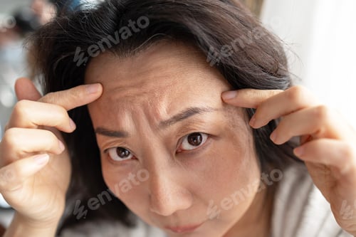 Preview: closeup portrait of Asian middle age woman showing her skin