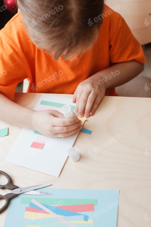 Preview: Little Girl Making Christmas Card sitting by table