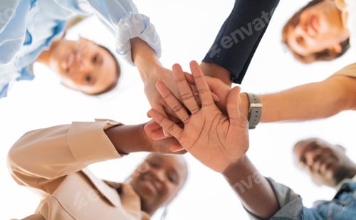 Preview: Happy multiethnic young friends holding hands together