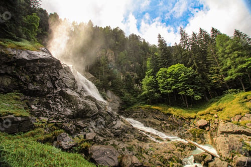 Preview: Breathtaking view of the Lares Waterfall in Pinzolo on a sunny day