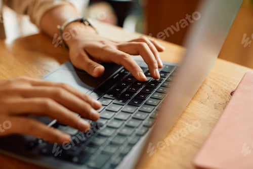 Preview: Close-up of businesswoman typing an e-mail on laptop.