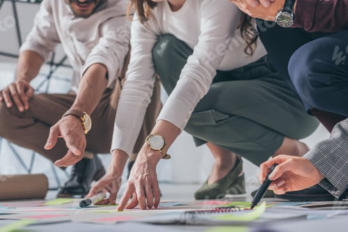 Preview: cropped view of scrum masters pointing with fingers at floor with sticky notes