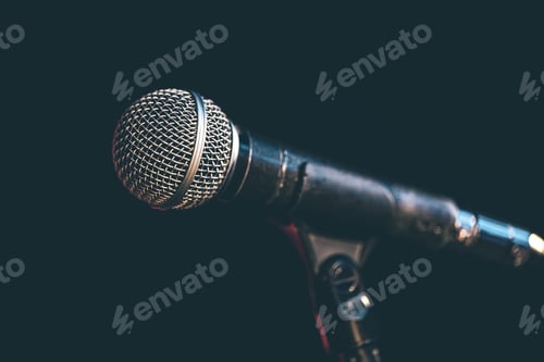 Preview: Close-up of a microphone in the dark.
