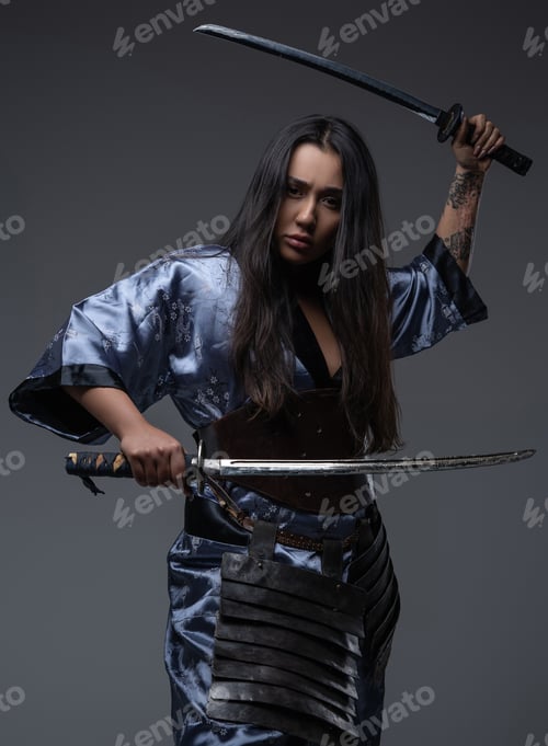 Preview: Aggressive woman samurai in fight stance with katanas