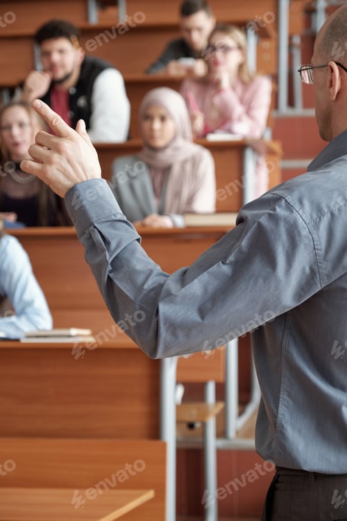 Preview: Teacher gesturing in front of group of students