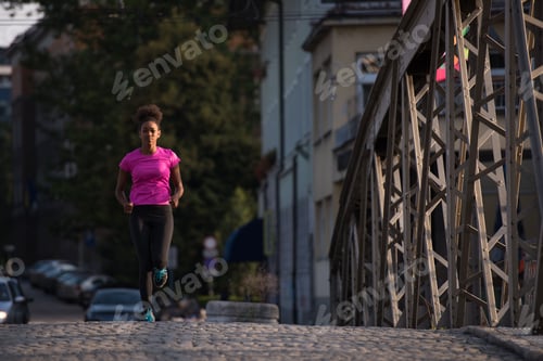 Preview: african american woman running across the bridge