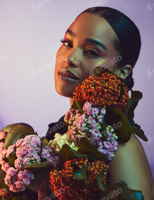 Preview: Studio portrait of an attractive young woman posing with a bouquet against a colourful background